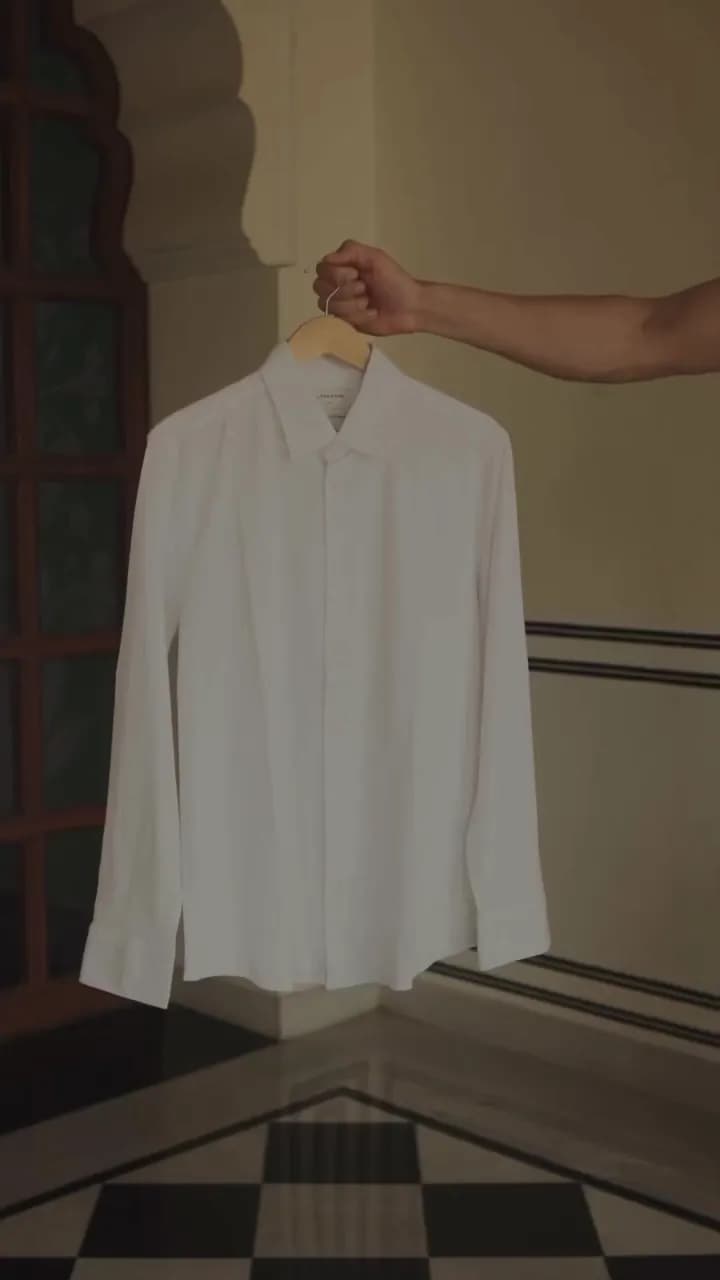 Black-tie menswear film: a white dress shirt built up into a tuxedo in a heritage palace